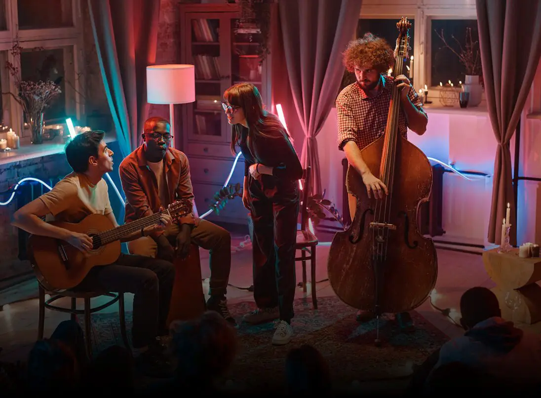 Musicians performing in a cozy living room.